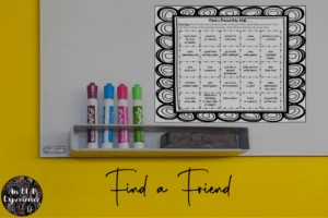 A handout for a find-a -friend activity is displayed on a dry erase board.