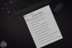A class rules worksheet is pictured on top of a desk.